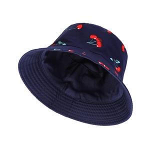 Double-sided cotton bucket hat with dark blue canvas and vibrant red cherry print