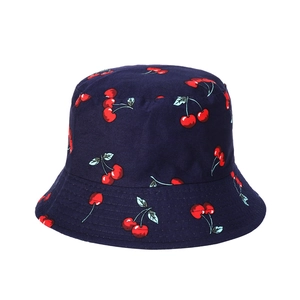 Detail of navy blue cotton bucket hat featuring all-over red cherry print patterns