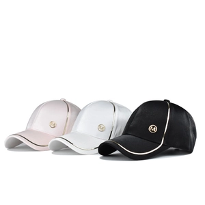 Fashionable baseball caps with gold metallic M logo in pink, white, and black colors