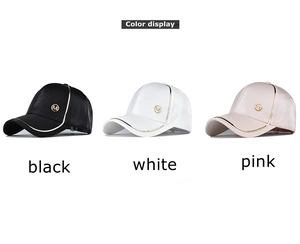 Three satin baseball caps in black, white, and pink with gold M logo and metallic piping
