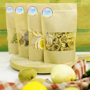 Kraft paper self-sealing bags with laser gold Thank You stickers on a wooden tray