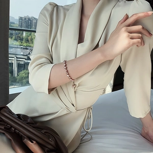 Detail of pink baroque freshwater pearl bracelet with adjustable metal clasp on model
