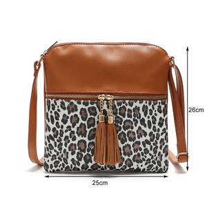 Detail view of leopard print crossbody bag with tassel charms, width 25cm and height 26cm