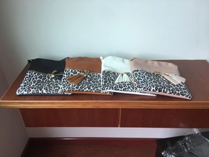 Detail showing four color-blocked crossbody bags with leopard print and double leather tassels