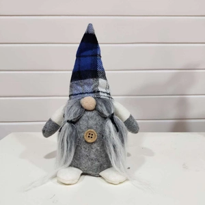 Nordic Christmas gnome plush with blue plaid hat and long white beard on a wooden background