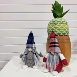Close-up of blue and red plaid Nordic gnomes with long beards for Christmas decor