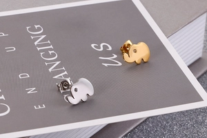 Detail view of elephant-shaped studs in gold and silver steel with zircon eyes