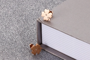 Macro shot of rose gold four-leaf clover stud earrings with a small diamond inlay detail