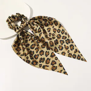 Detail shot of leopard print satin hair scrunchie with long ribbons on white base