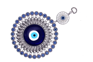 Macro shot of silver evil eye wall decor with detailed metal patterns and blue glass beads