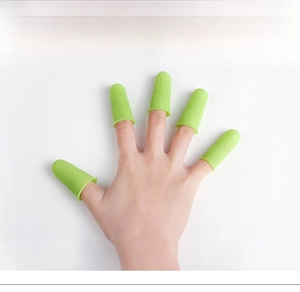 Close-up of green silicone finger guards with non-slip dots for protection and grip