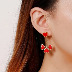 Fashionable red heart drop earrings with gold trim and elegant triple heart pendant design