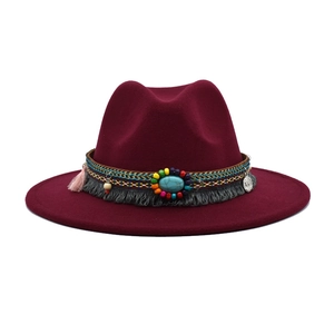 Detailed view of burgundy wool fedora with bohemian beadwork and turquoise accent