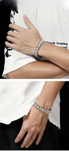 Macro shot of silver hip-hop bracelet links with sparkling white cubic zirconia pavé
