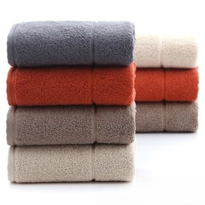Detail of stacked thick cotton towels showing soft terry texture in assorted colors
