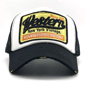 Front detail of mesh trucker hat with vintage Western embroidery on a yellow patch