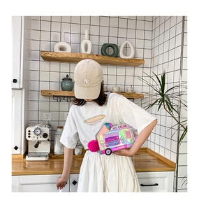 Colorful laser ice cream truck shoulder bag with gold chain strap and pink pom pom detail
