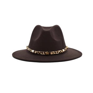 Detail of dark brown fedora hat featuring leopard print band with gold star studs