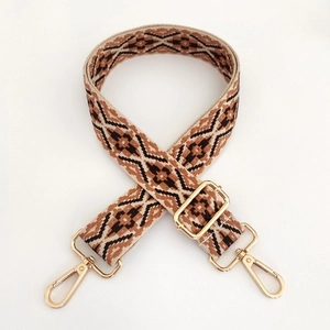 Detail of 3.8cm jacquard bag strap with bohemian geometric pattern and gold swivel hooks