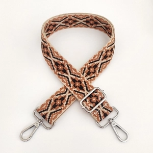 Detail of 3.8cm adjustable woven bag strap with retro geometric patterns and silver buckles