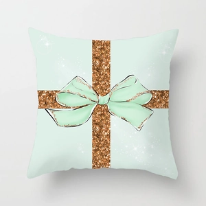 Detail of mint green Christmas cushion cover with rose gold glitter bow print design