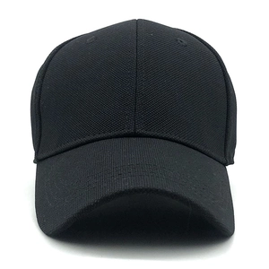 Detailed close-up of a minimalist black cotton baseball cap with a classic curved brim