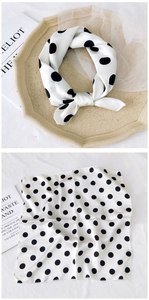 Detailed view of square silk scarf with classic black and white polka dot pattern design