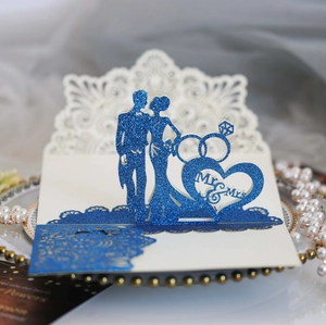 Detail of laser-cut wedding card with 3D blue glitter Mr & Mrs pop-up and rings