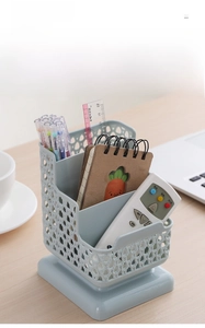 Macro view of light blue hollowed-out plastic desk organizer with three tiers of storage