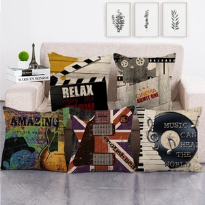 Detailed view of six vintage movie and music themed linen cushion covers on a sofa