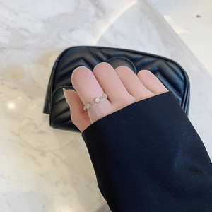 Minimalist gold open ring featuring elegant white cat-eye stones for a modern look