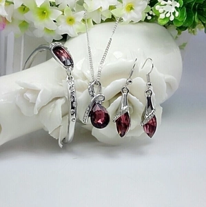 Fashion silver jewelry set with dark red teardrop crystals and sparkling small diamonds