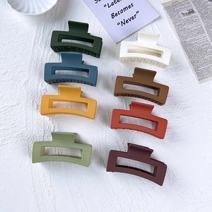 Matte square hair claw clips set in 8 Morandi colors on a stylish textured background