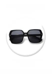 Macro shot of black square sunglasses featuring a metal D-logo and model YT7757 details
