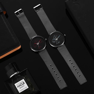 Business quartz watch with silver mesh strap and blue hands set on black background