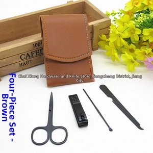 Detail of 4-piece black matte grooming kit in a brown faux leather case with tools