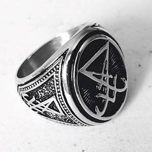Macro detail of gothic signet ring featuring engraved seal of Lucifer and relief texture
