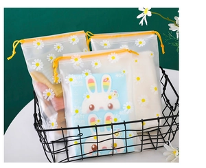 Frosted daisy drawstring bags for toiletries stored in a stylish black wire basket