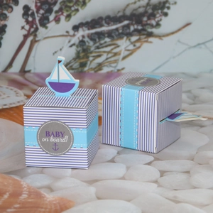 Blue and white nautical baby shower gift box with sailboat topper and baby on board label