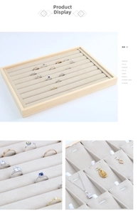 Macro shot of wooden jewelry tray with beige velvet lining and multiple ring slot details