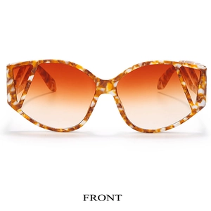 Front view of geometric cat-eye sunglasses with orange tortoise frame and gradient lenses