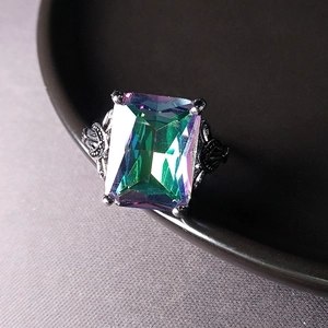 Vintage ring with large rectangular rainbow topaz and intricate silver floral engraving