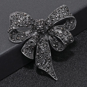 Fashionable black bow brooch featuring vintage metal carving and sparkling rhinestones