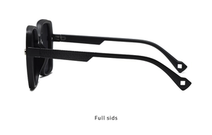Detail view of square black sunglasses with textured geometric relief on the side temples