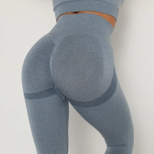 Detail of high waisted dusty blue seamless leggings with peach lift structural stitching