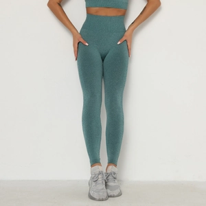 Detail view of high-waist seamless teal yoga leggings and matching sports tank top