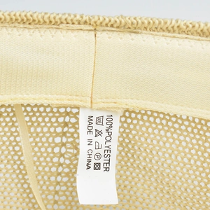 Close-up of the breathable mesh interior and washing label on this polyester beret