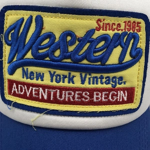 Close-up of vintage Western 3D embroidery patch on a blue and white mesh trucker hat