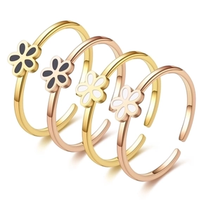 Detailed view of adjustable floral rings in gold and rose gold with enamel petals
