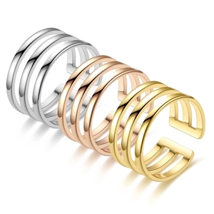 Detailed shot of adjustable open rings in silver, gold, and rose gold with four-layer design